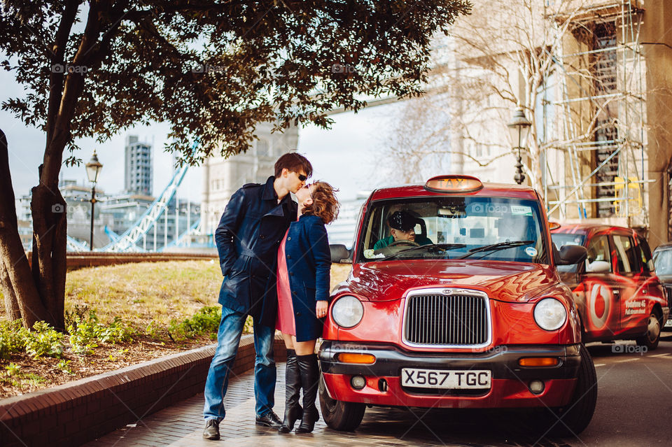 Cute couple kissing near car