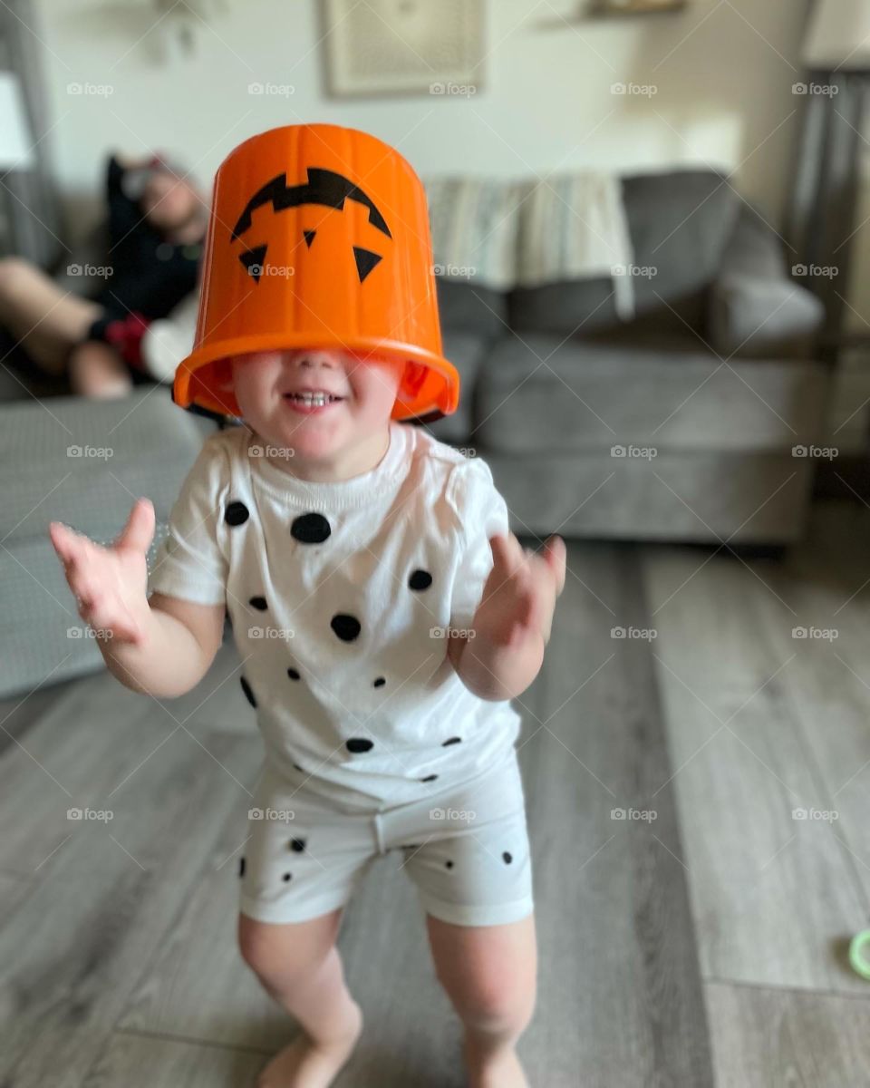 To a two year old, Halloween is magical. My two year old with his Halloween bucket on his head. 
