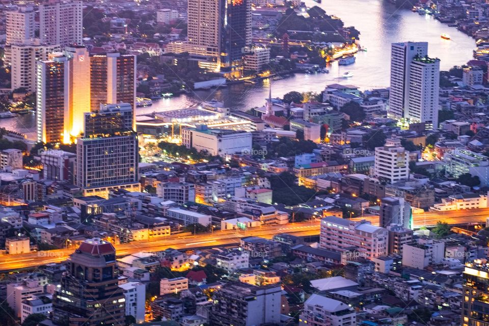 Night light of high building in the capital city Bangkok Thailand , Mahanakorn building roof top view