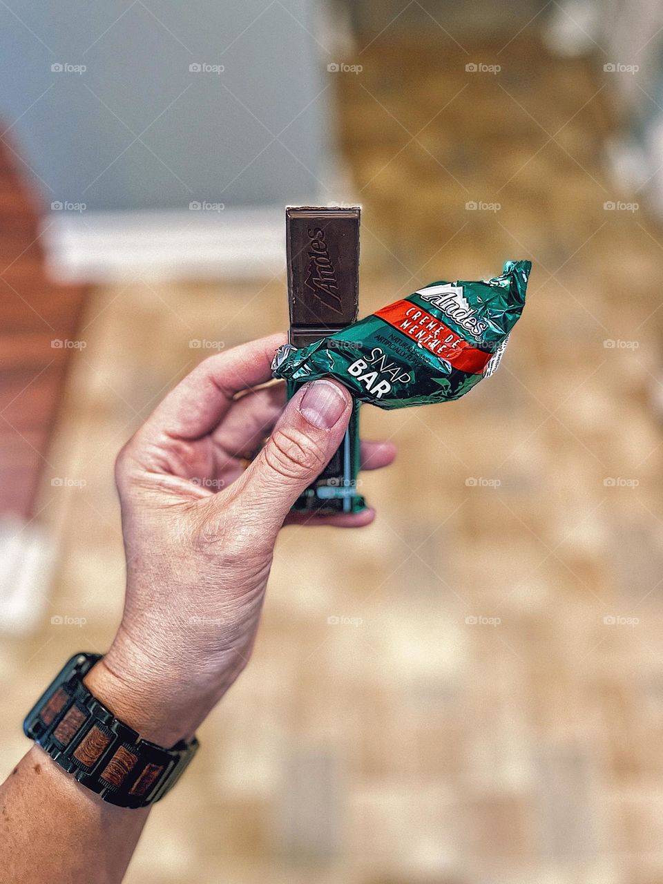 Eating an Andes Snap Bar, woman’s hand holding a candy bar, woman eating a candy bar, woman holding a candy bar treat, Andes Snap Bar product 