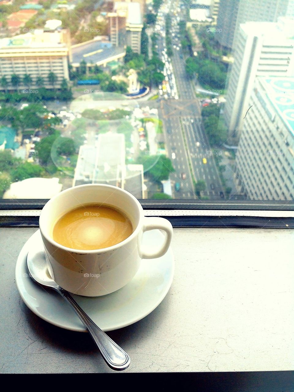 coffee drink on a window overlooking urban city