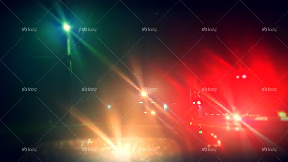 Tons of stuff going on here. Railroad crossing in the evening cars and their lights.