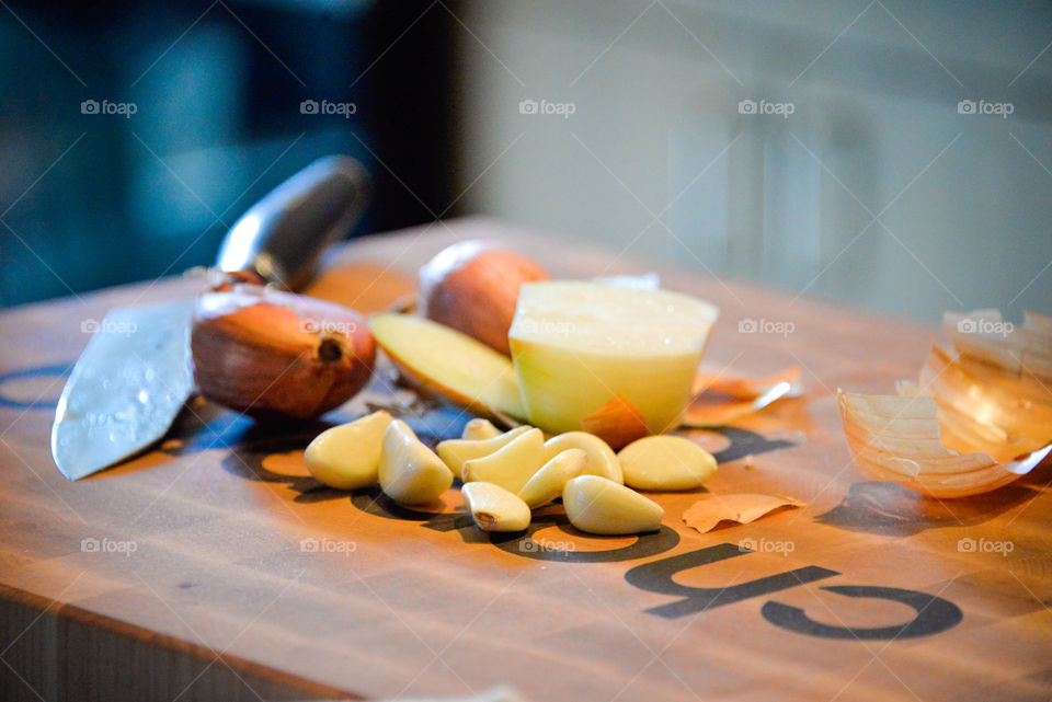 Garlic and onion being prepared for a dish