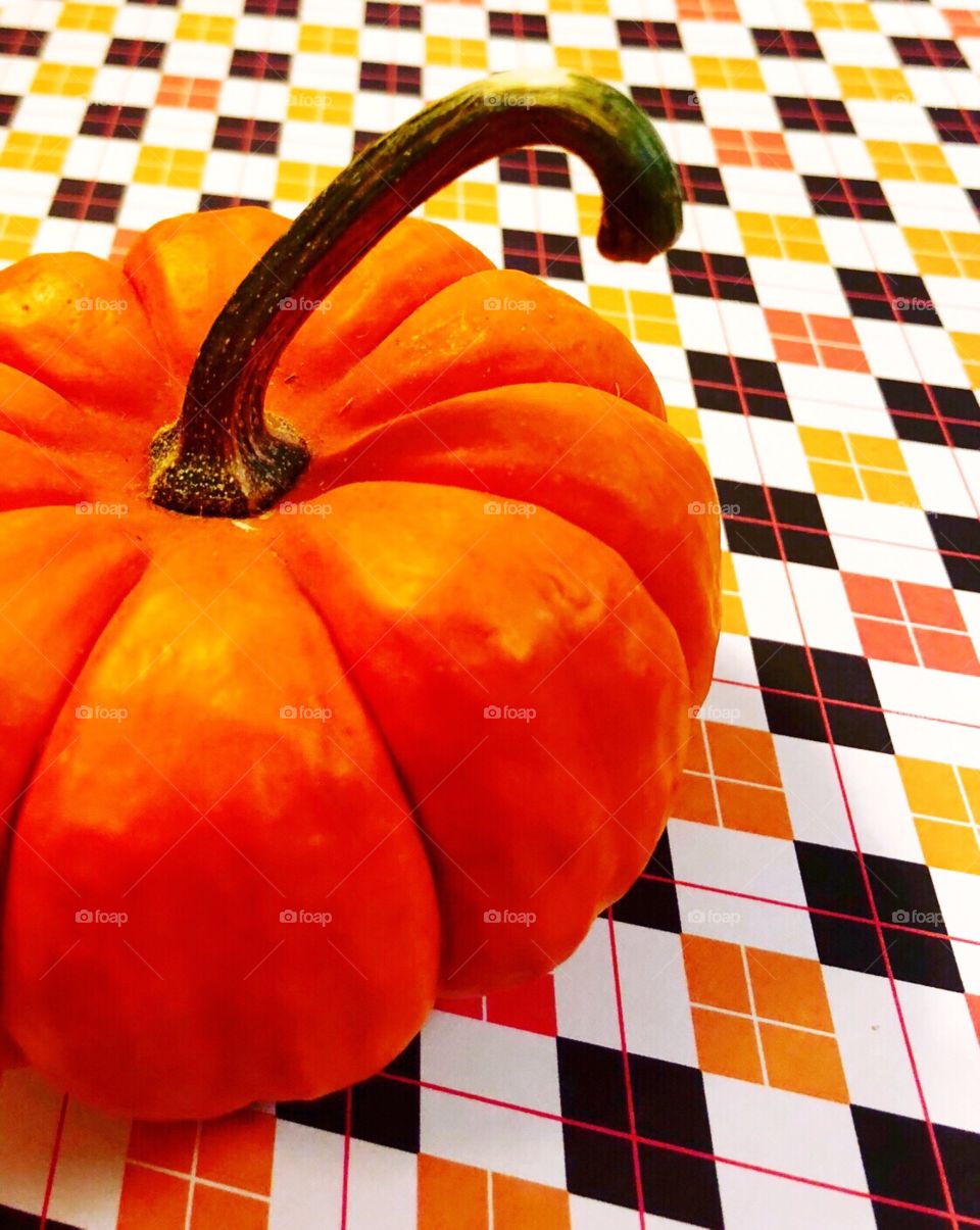 Pumpkin on a Halloween colored background. 