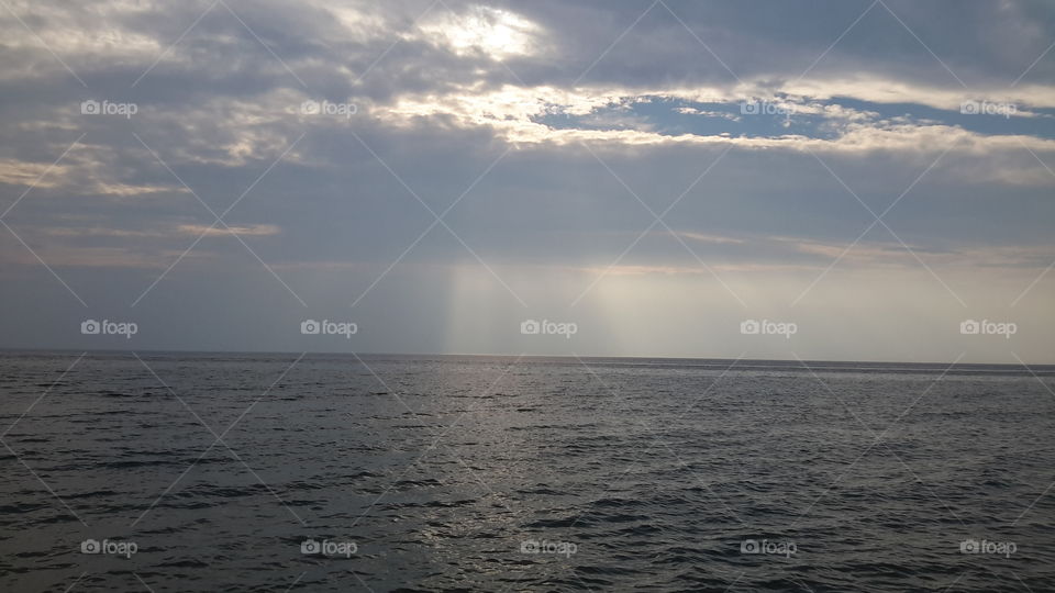 the sun shining on cloudy day