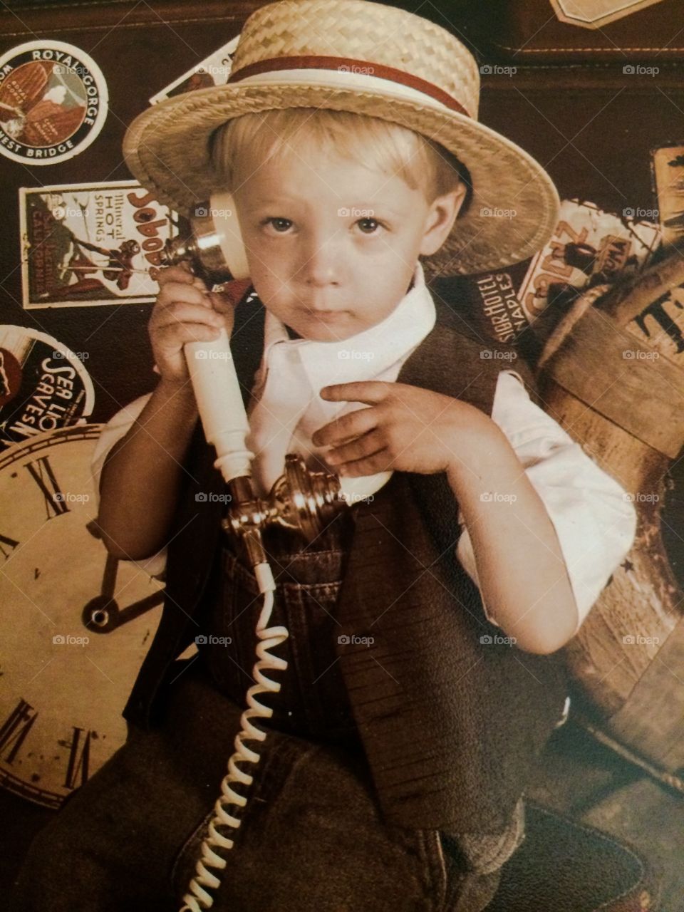 Portrait of little boy holding telephone