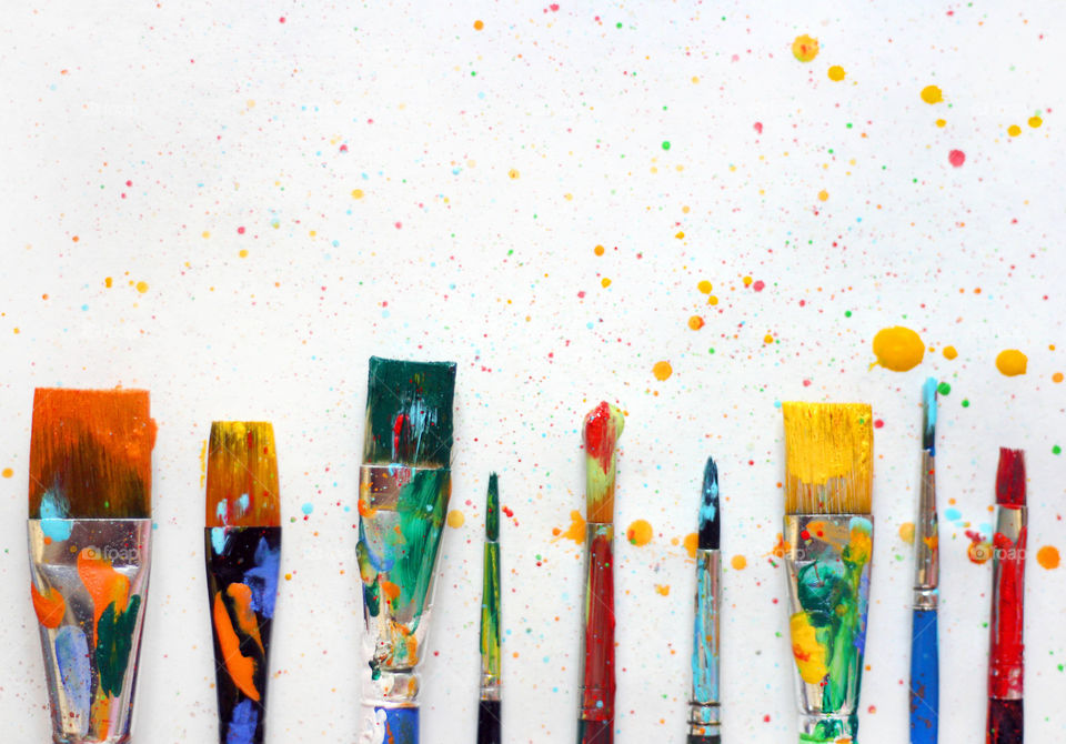 Colorful painted paintbrushes, colorful splash, artistic background