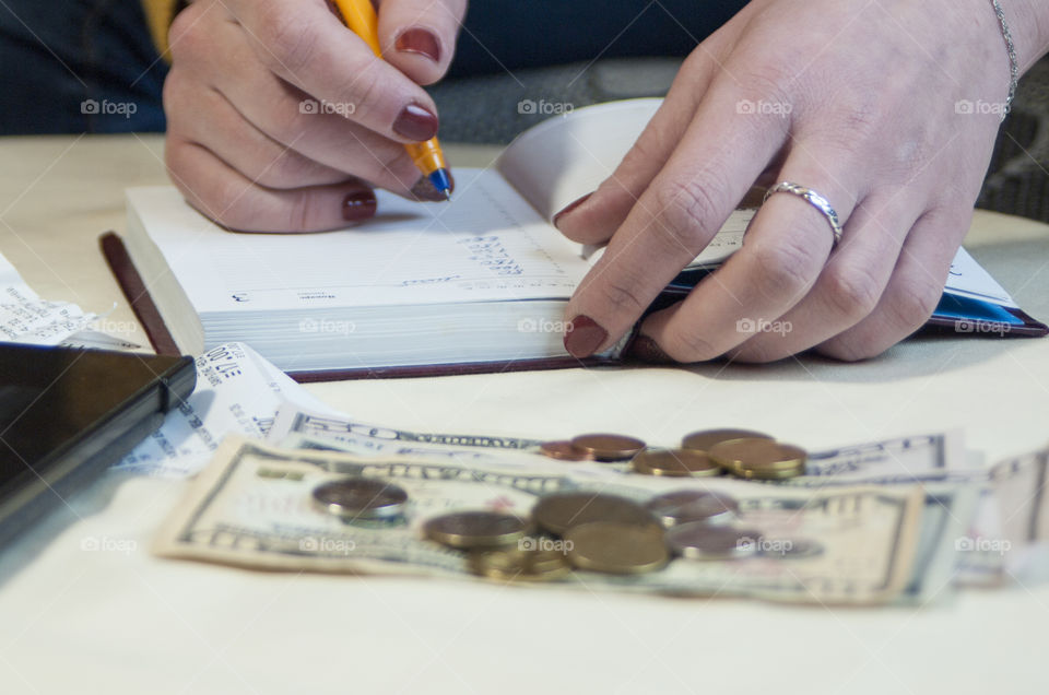 woman takes notes in notepad and says Finance