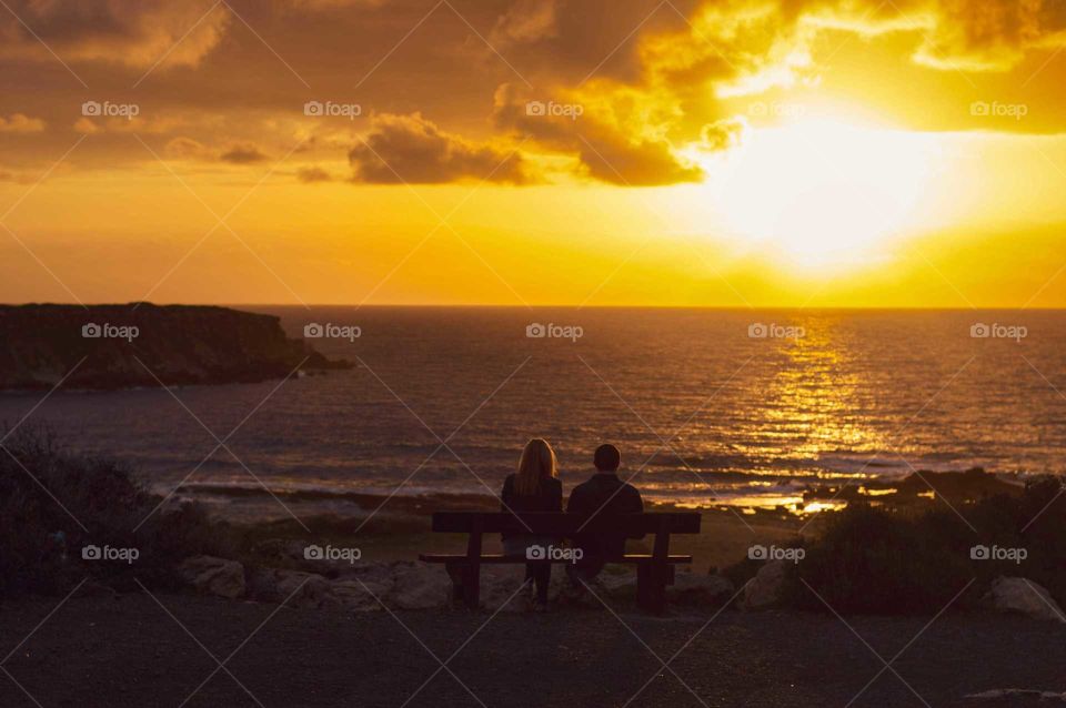 Watching sunset on the beach with friends and enjoying the beauty of mother nature.