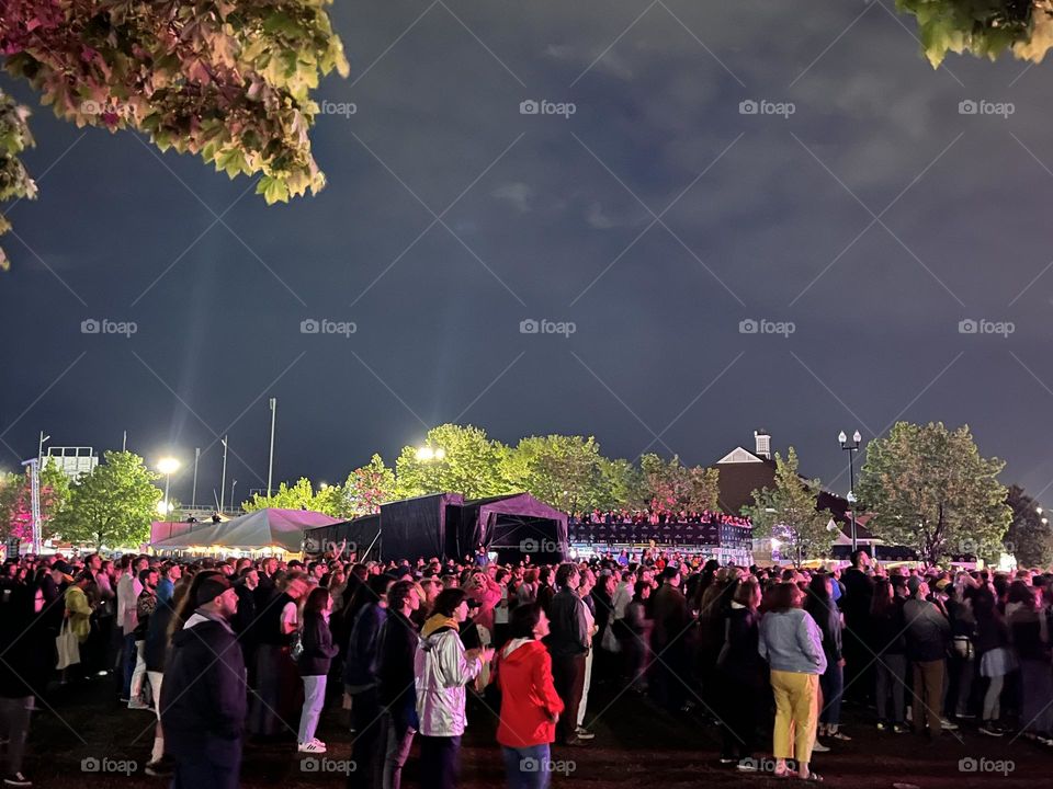 After a rainstorm the crowd reassembles to cheer on the band to continue with the show 