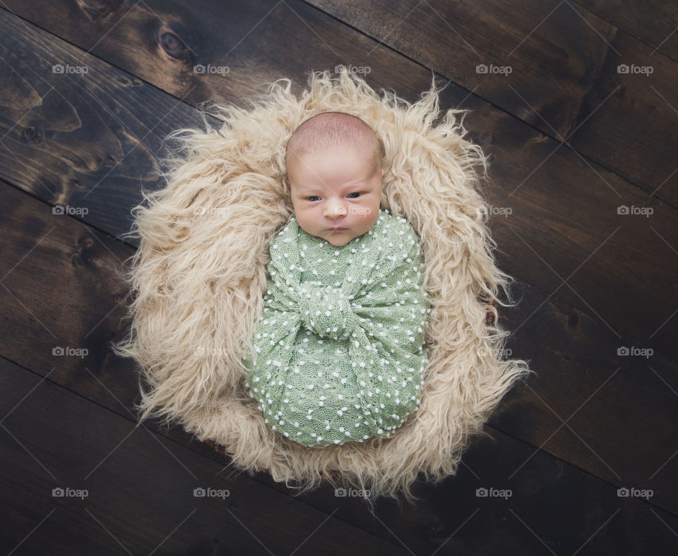 Elevated view of a baby wrapped in cloth