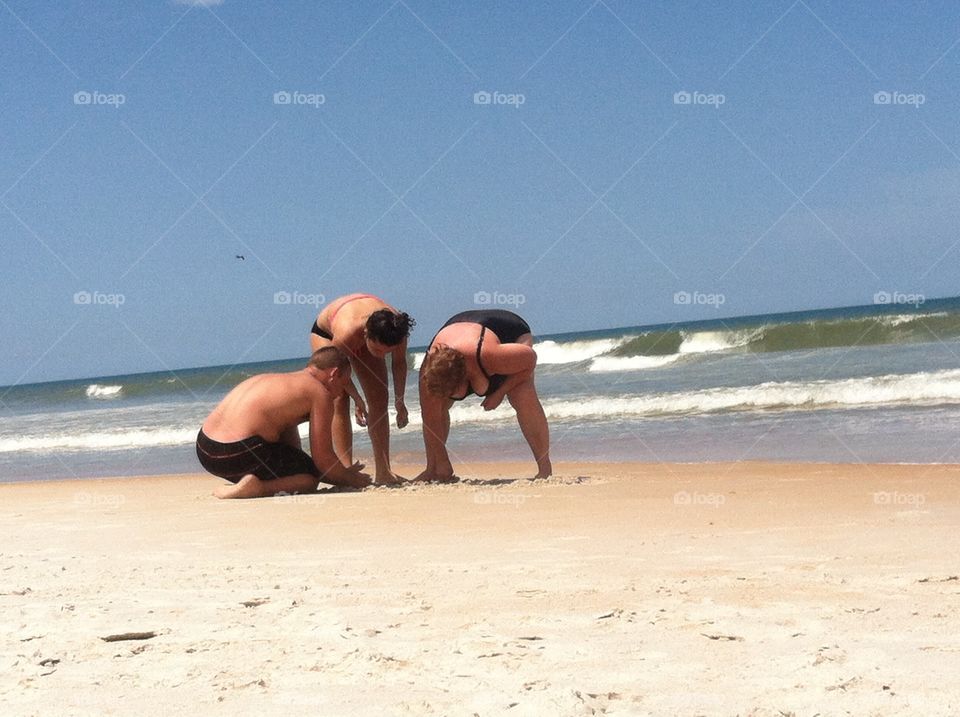 Setting up a game. Setting up to play washers on the beach 