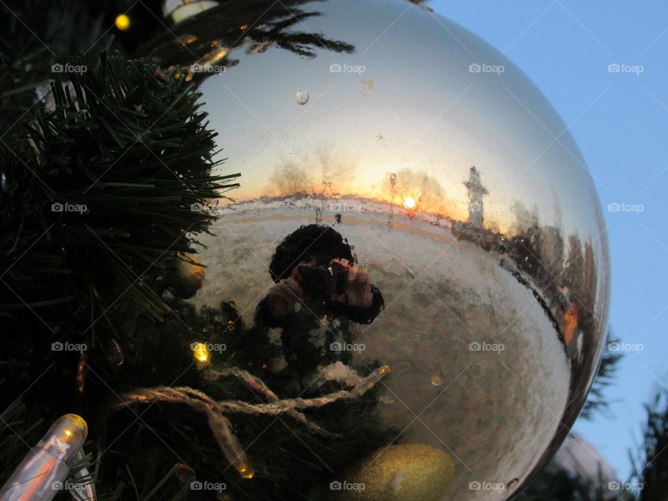 reflection in a glass mirror ball on a Christmas tree