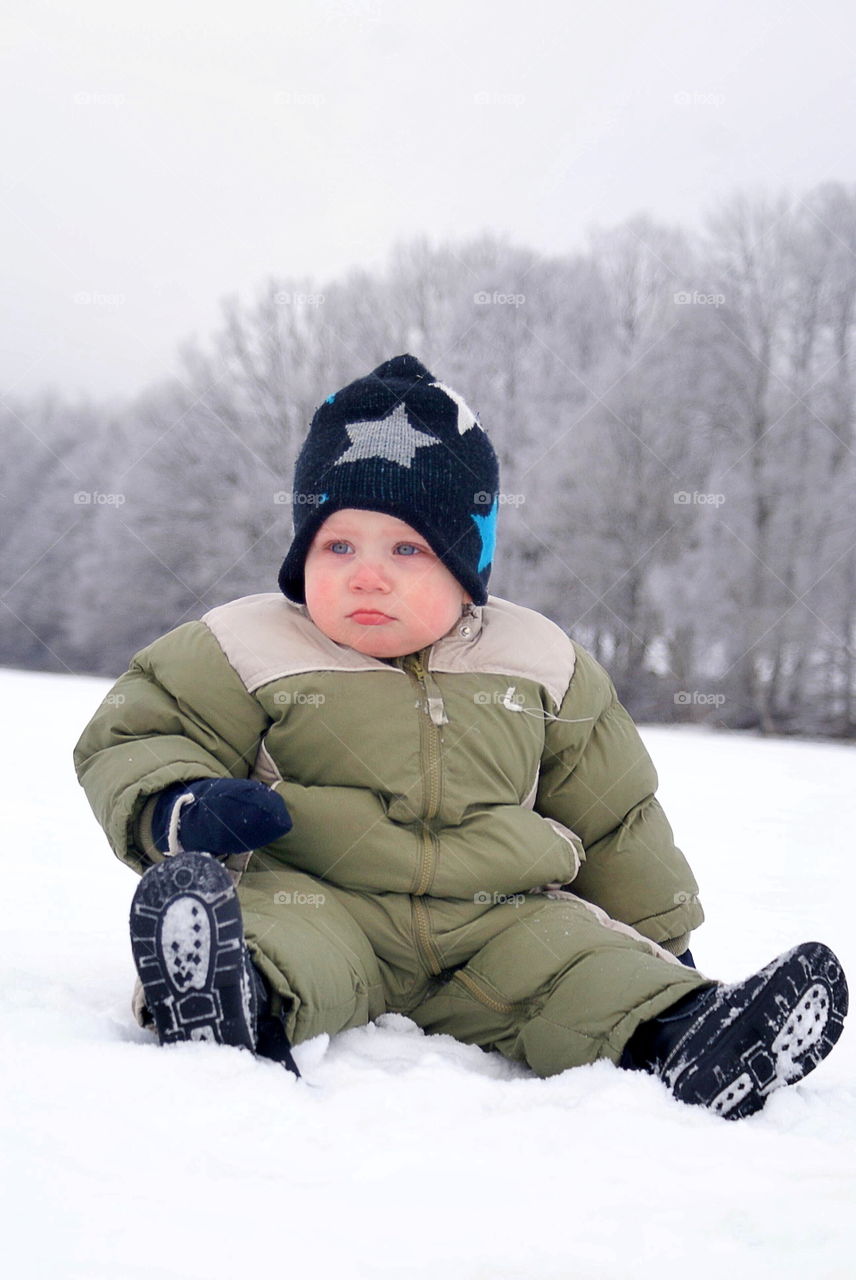 Cute and angry toddler in the snow