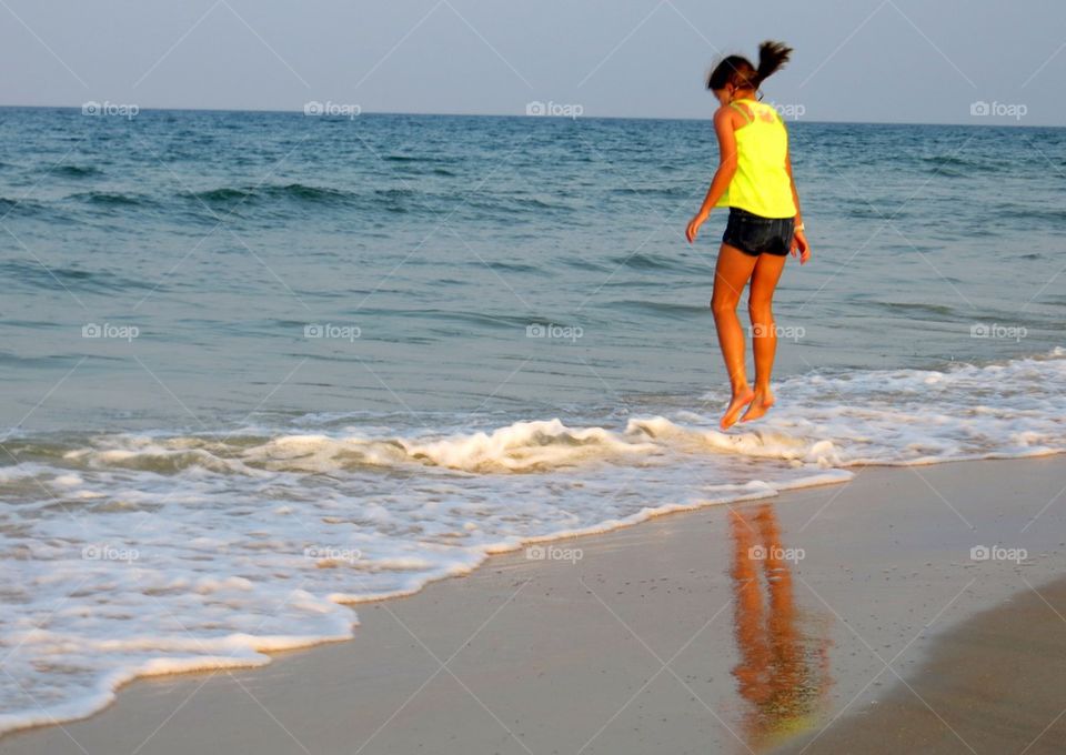 Girl jumping at beach