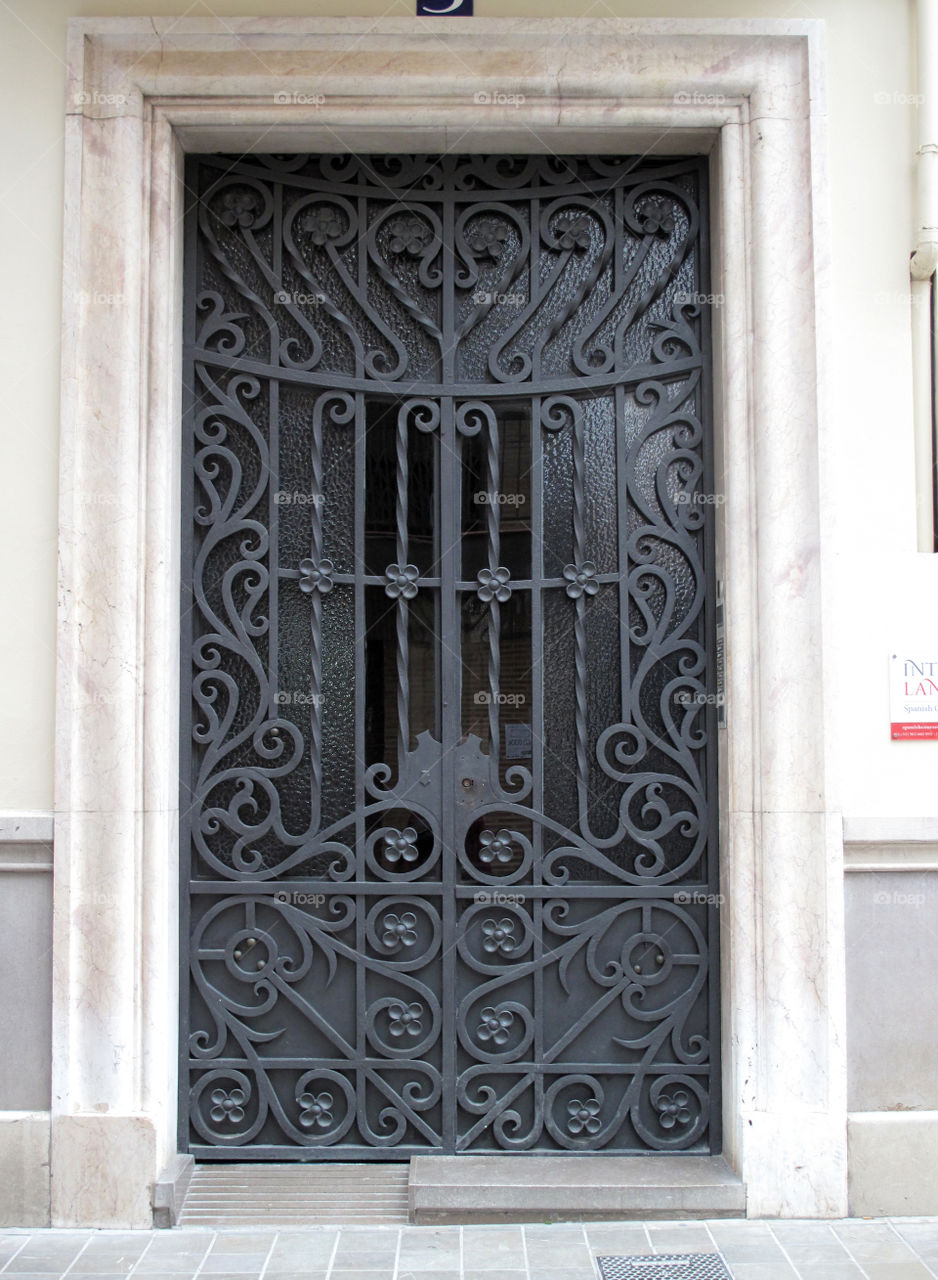 Metal door with an openwork lattice