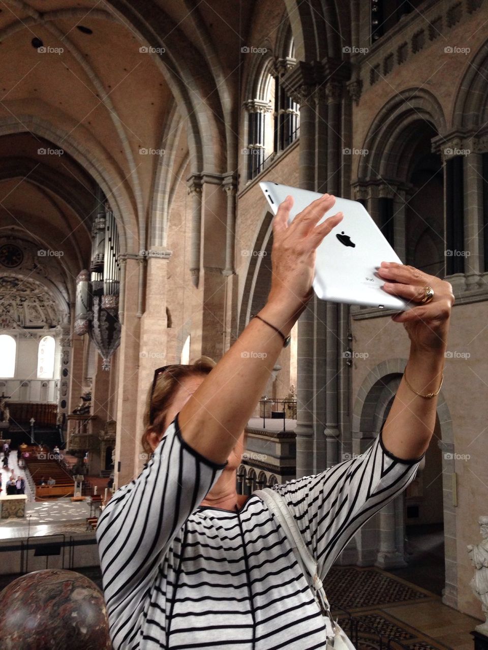 Woman taking a picture/selfie with an ipad