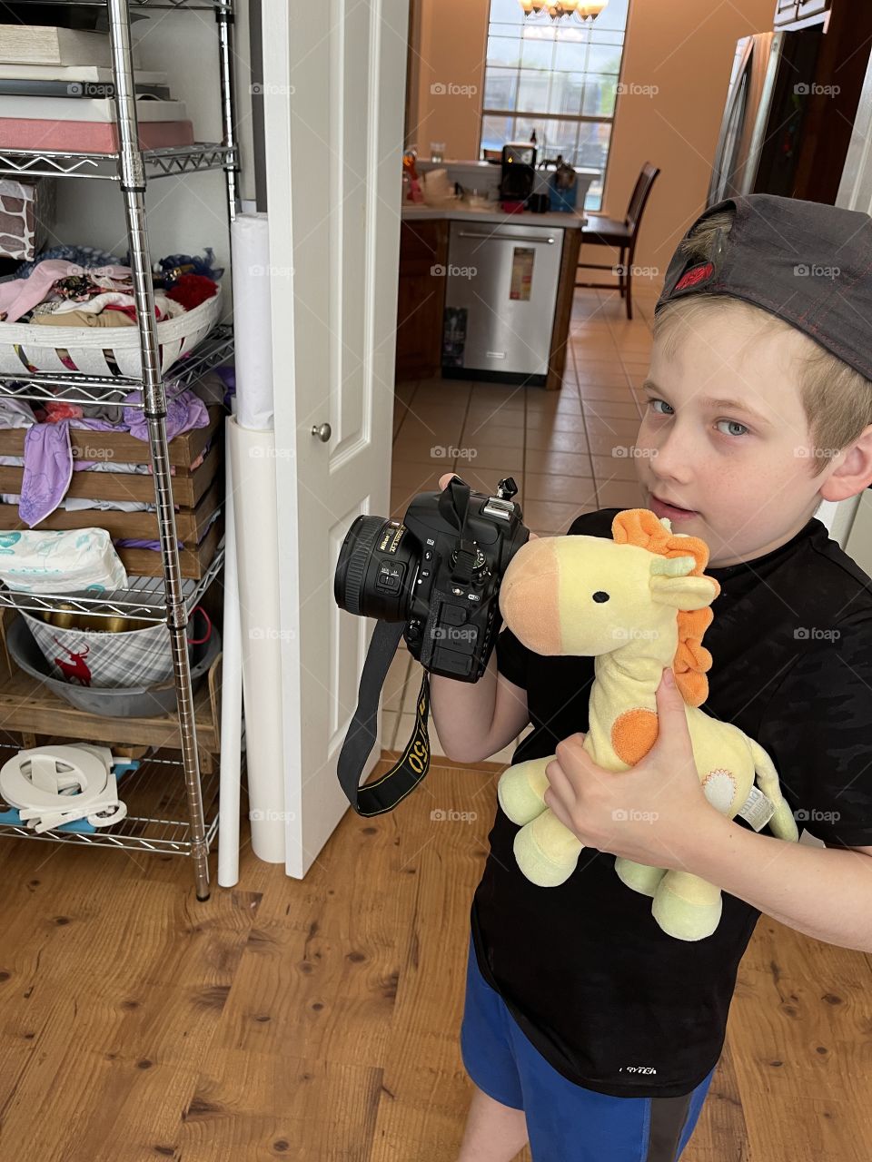 Silly boy teaching a stuffed giraffe photography 