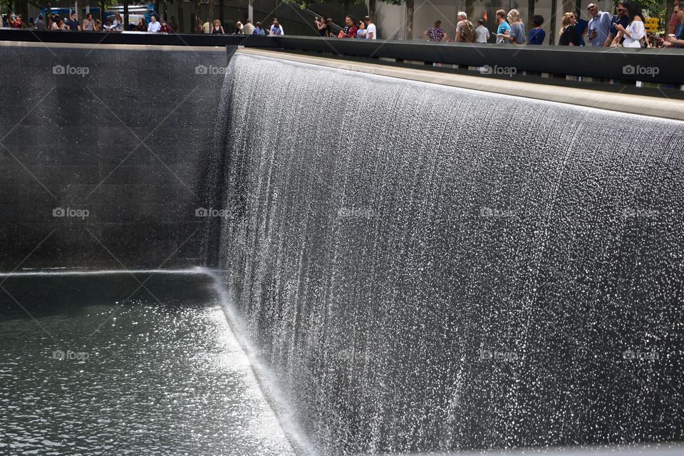 Reflecting Absence Memorial, the largest man-made waterfall inside the 9/11 Memorial, symbolizing the vast void left by the tragedy. 