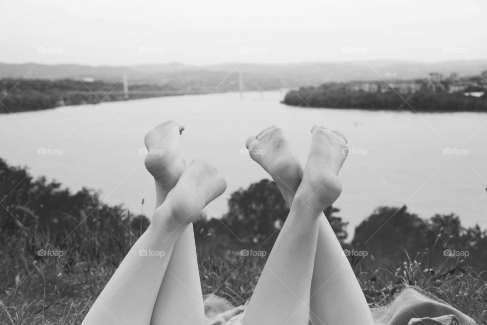 two barefoot friends. two girl friends lying barefoot enjoying summer