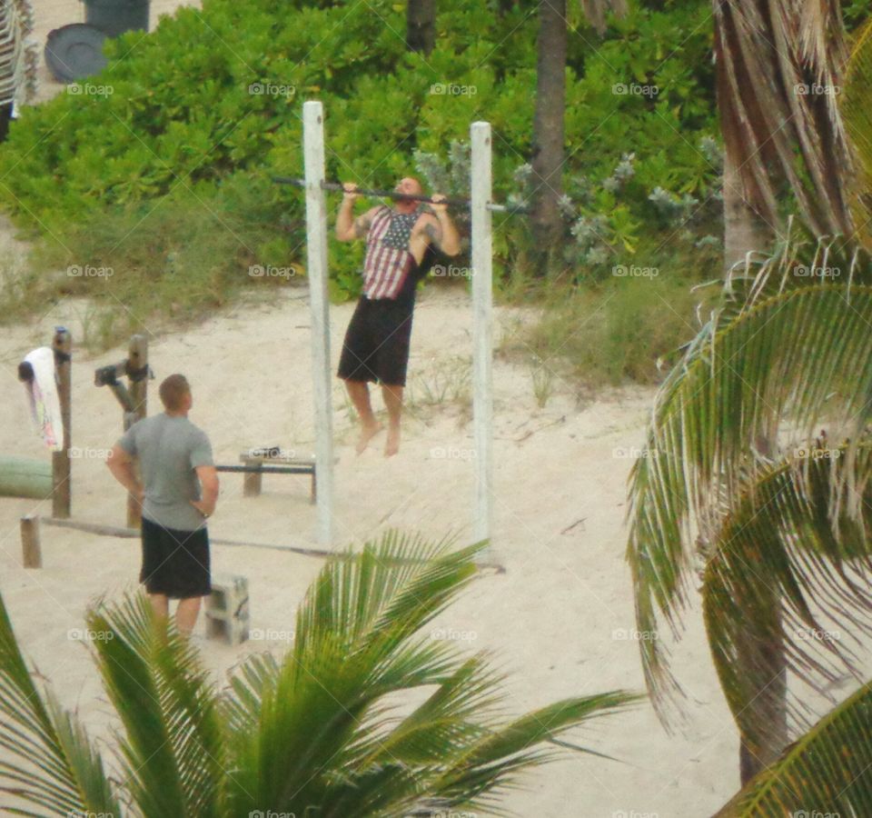 Working Out on the Beach, chin ups.