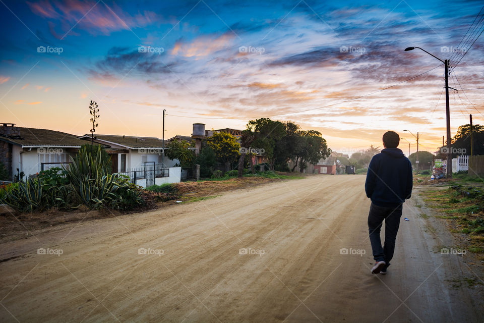 Rear view of a man walking on street