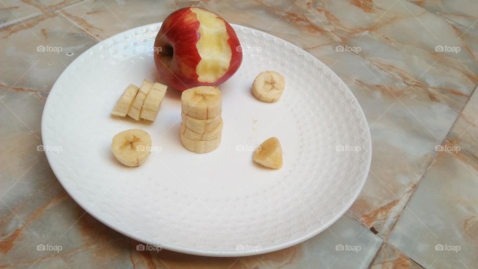 pieces of banana near a distilled apple.