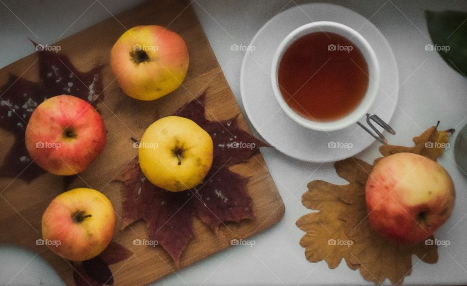 autumn composition apples on maple leaves with tea