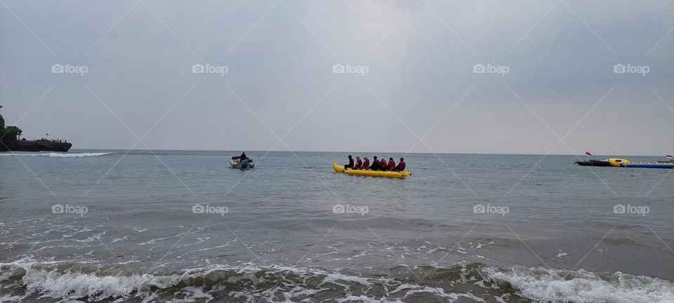 playing banana boat on the beach