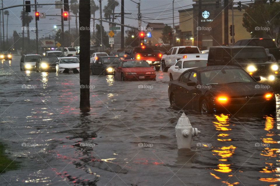 Flooded street in California! Cars trying to get through the water!