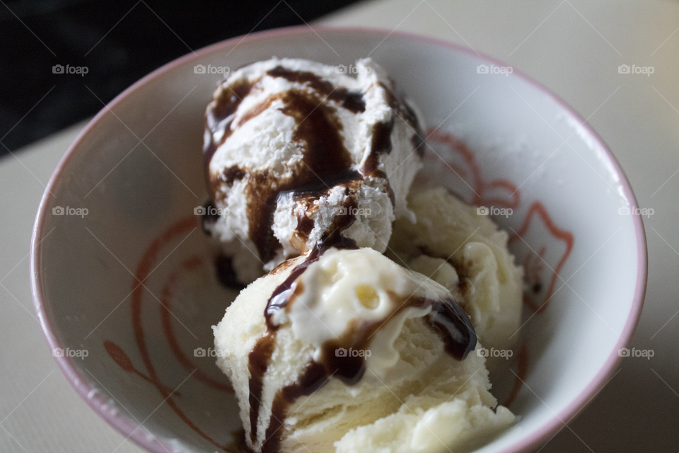 bowl with ice cream and chocolate syrup