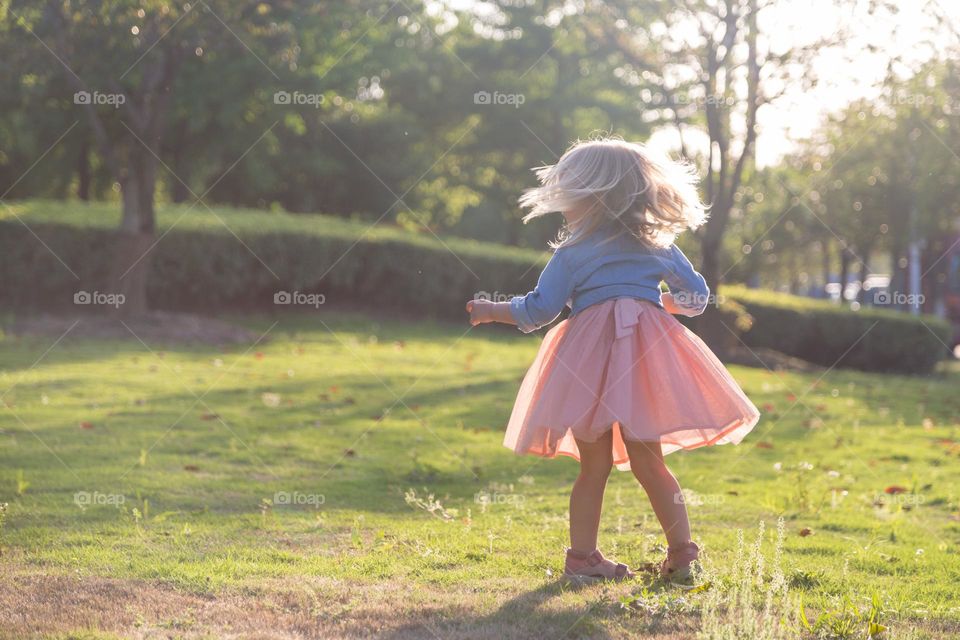 Cute kid having fun in park at summer 