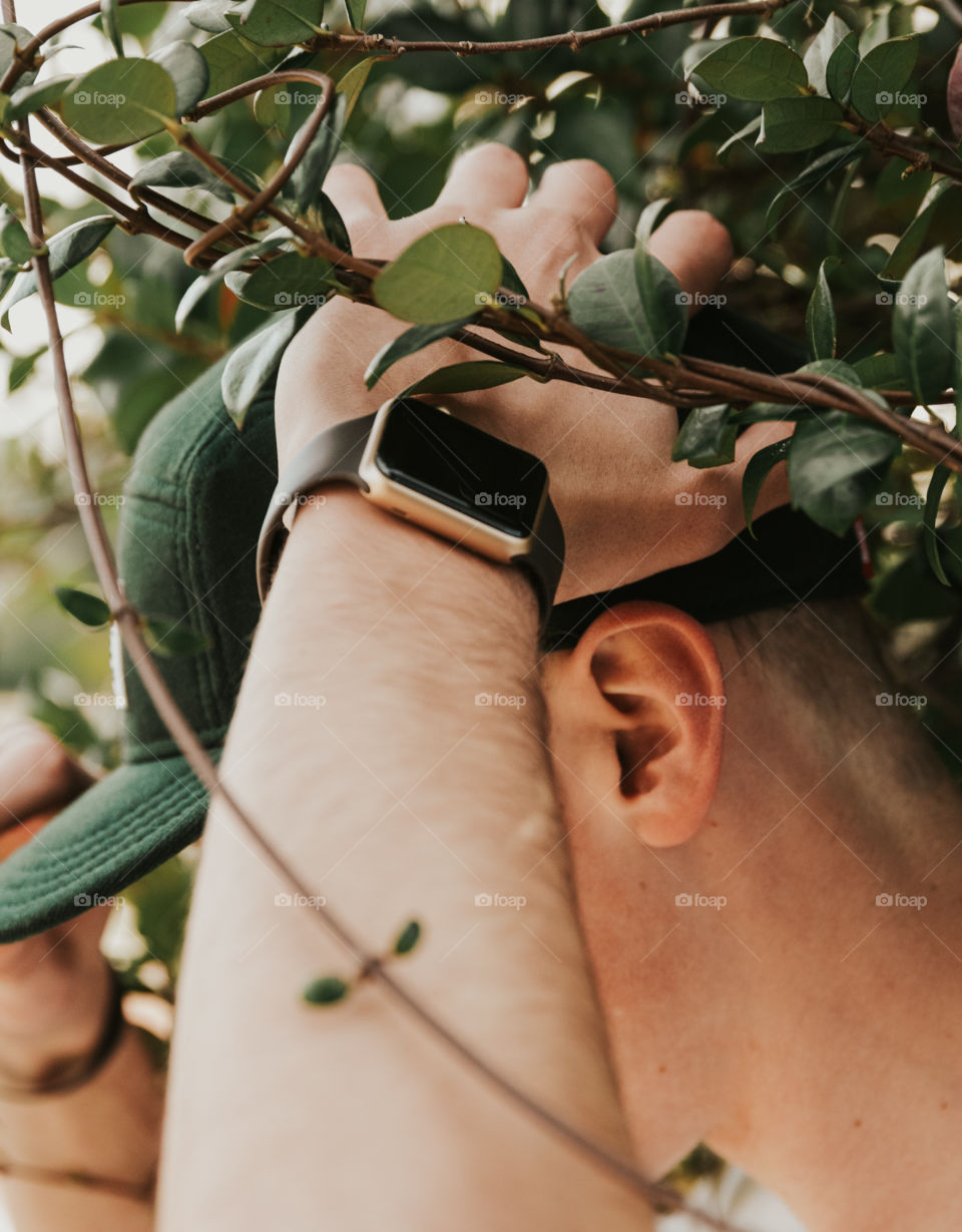 Stussy Hat and Apple Watch in Floral Backdrop