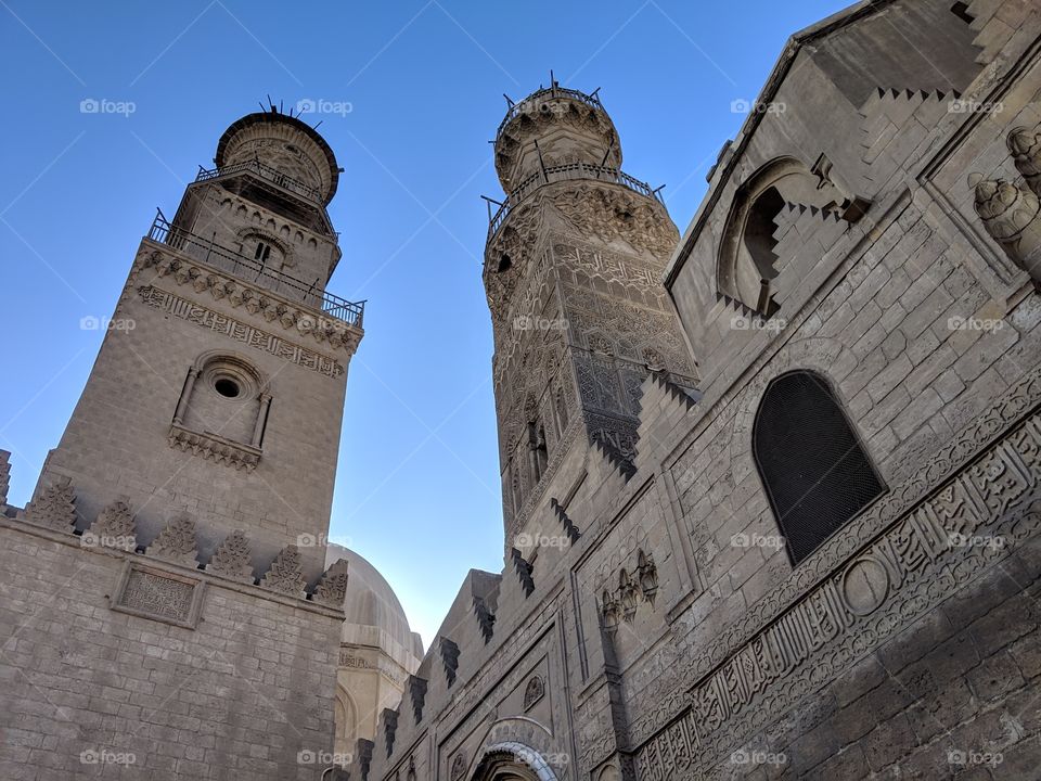 The towers of mosques against a blue sky in the old Islamic quarter of Cairo, Egypt