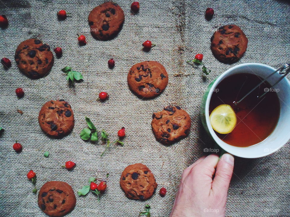 oatmeal cookies with chunks of chocolate and a cup of tea, dessert