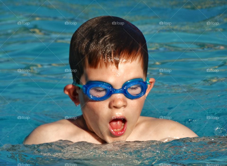 Young Swimmer. Young Boy Learning To Swim
