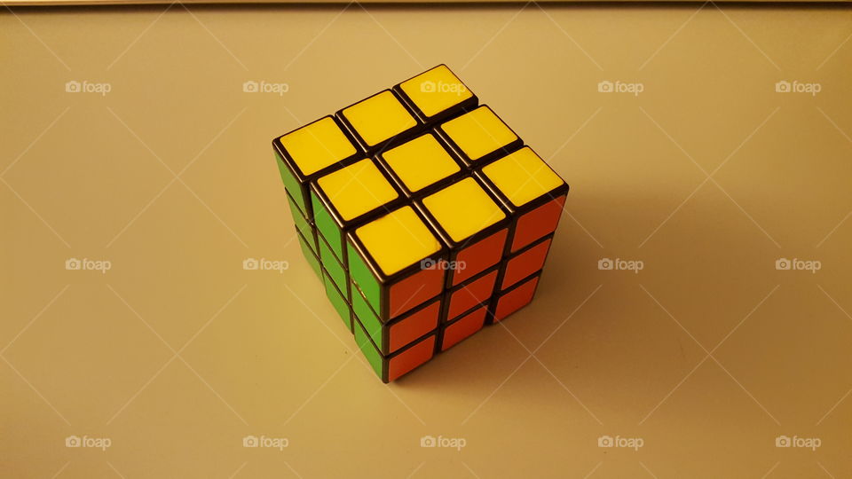 Finished rubiks cube with yellow green and red faces