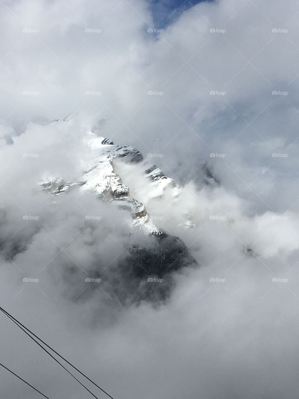 Snowy mountain hidden in the clouds 