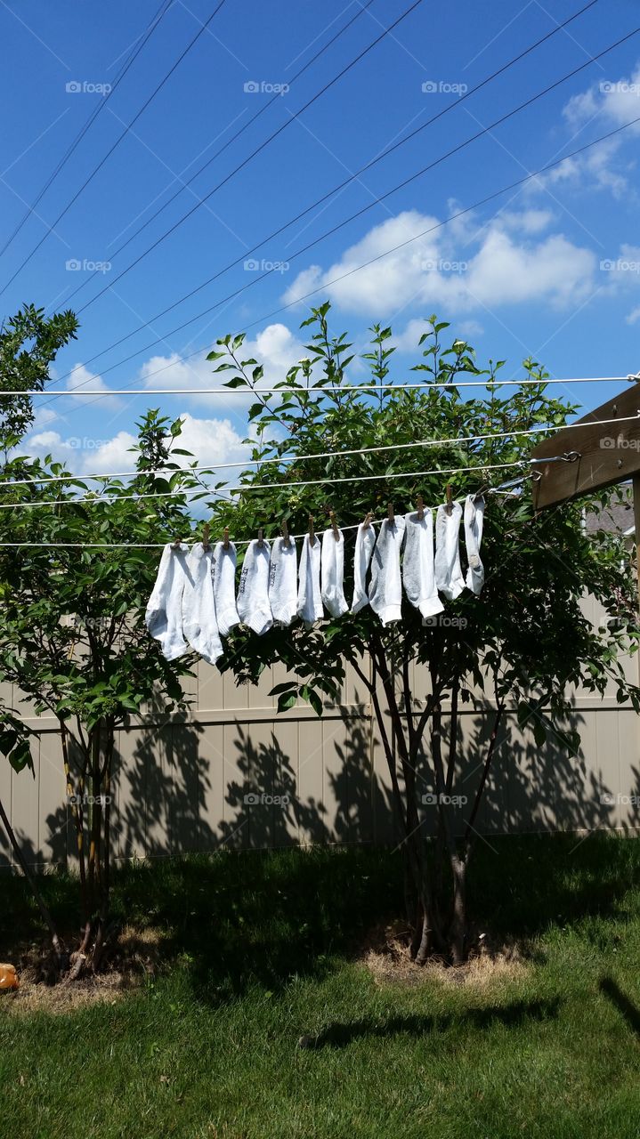 hanging socks on a clothesline. letting the Sun do its job