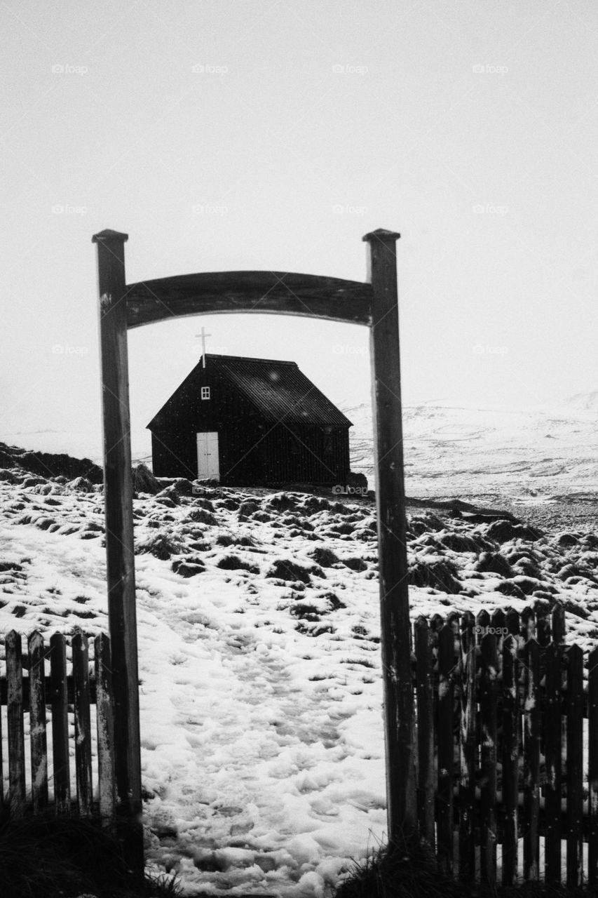 Black church through frame of entrance portal in Iceland in black-and-white.