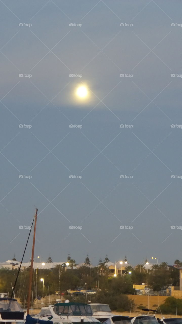 full moon over marina. full moon early in the evening,  Mindarie marina
