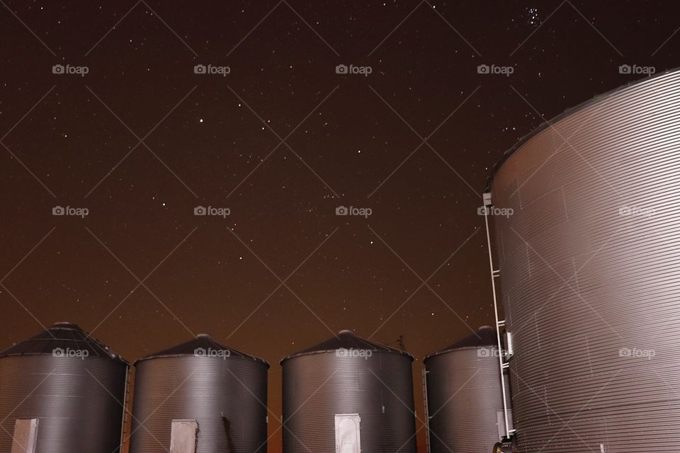 The seven sisters above some grain bins 