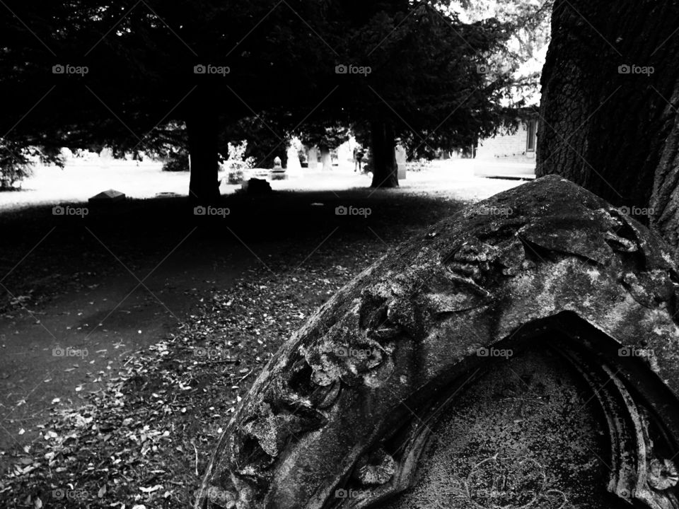 Gothic grave yard in black and white with gravestone and stone carving