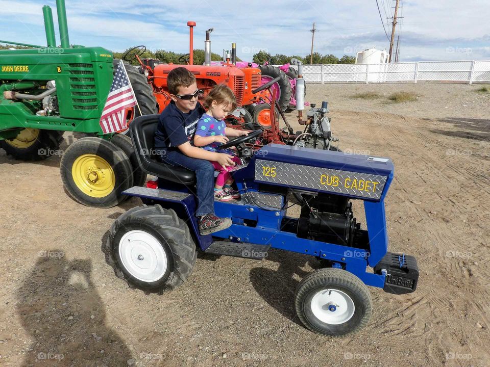 siblings on a tractor