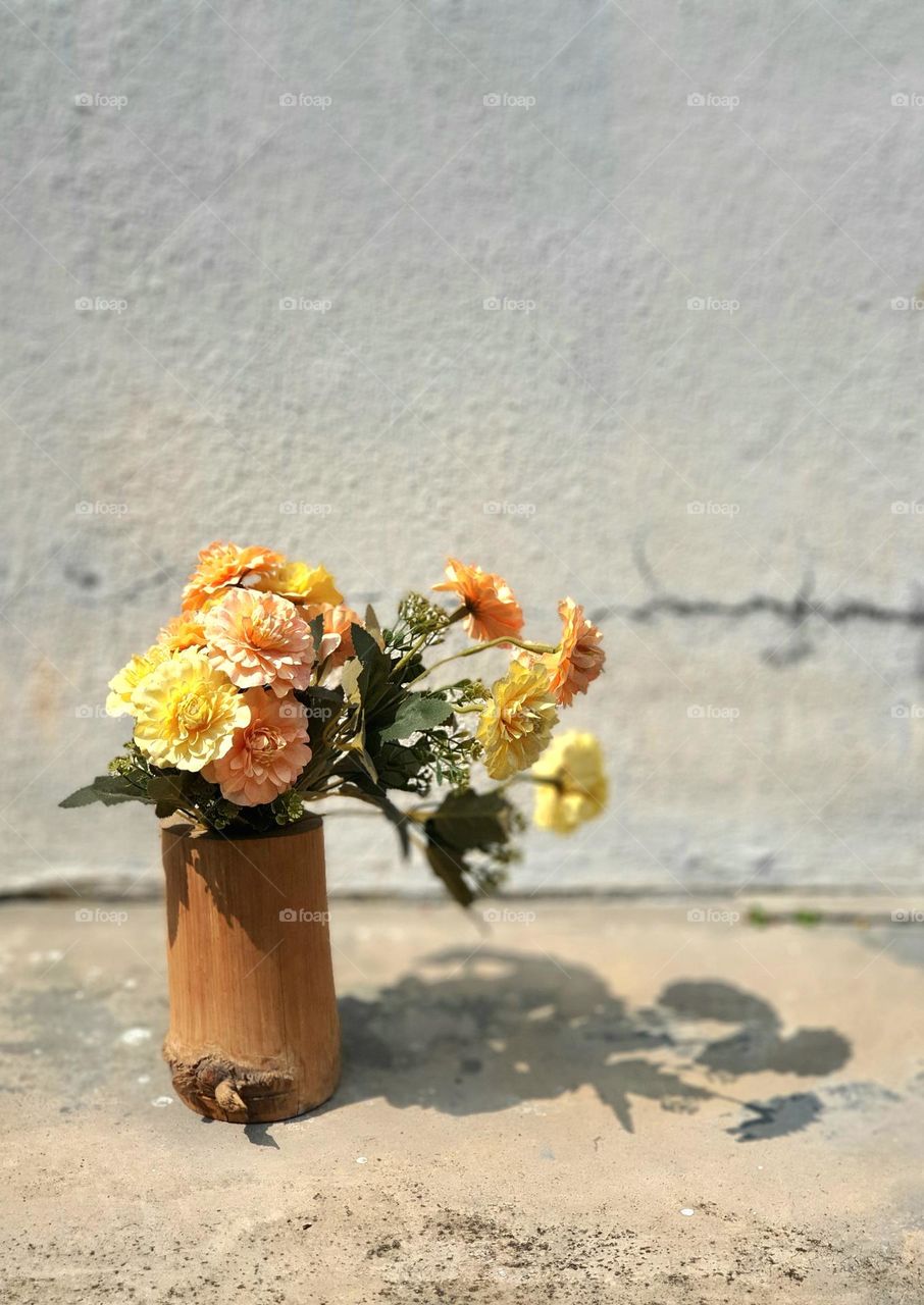 Flowers in Bamboo Vase with Shadow Reflection on a Sunny Day