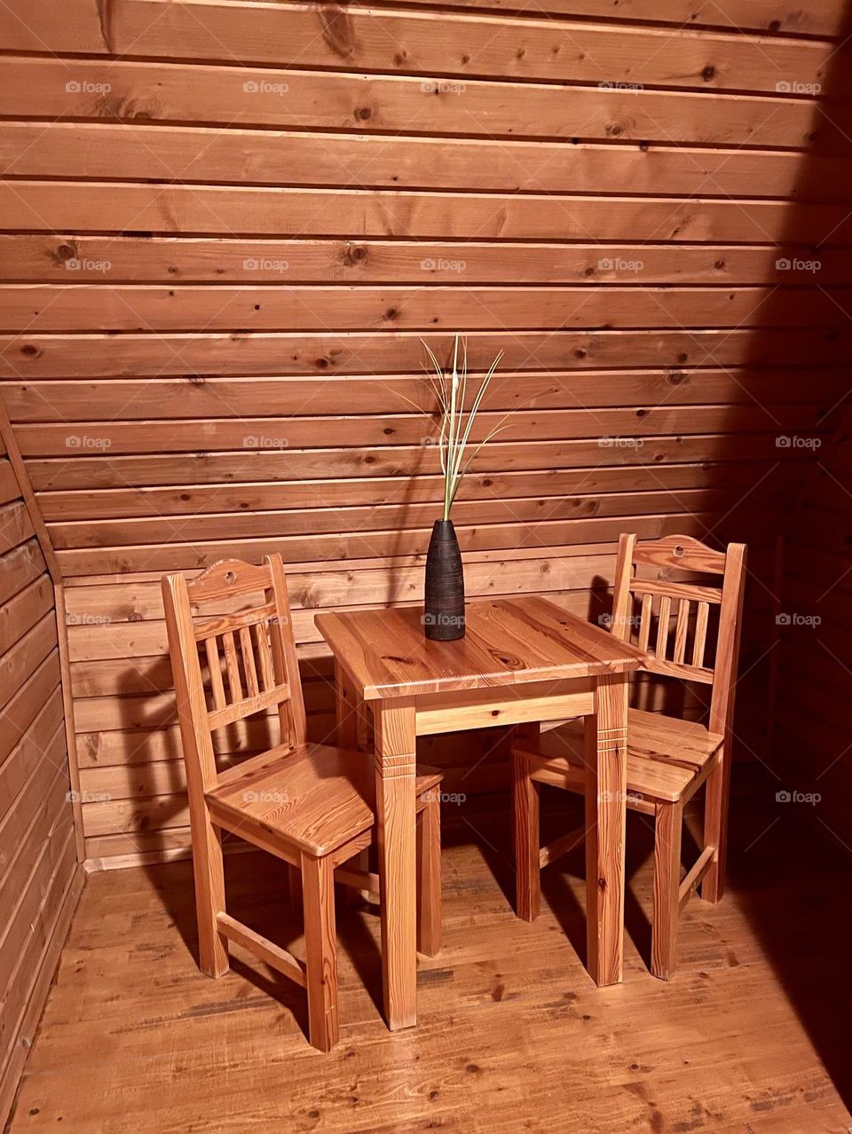Wooden room with wooden walls, table and chairs