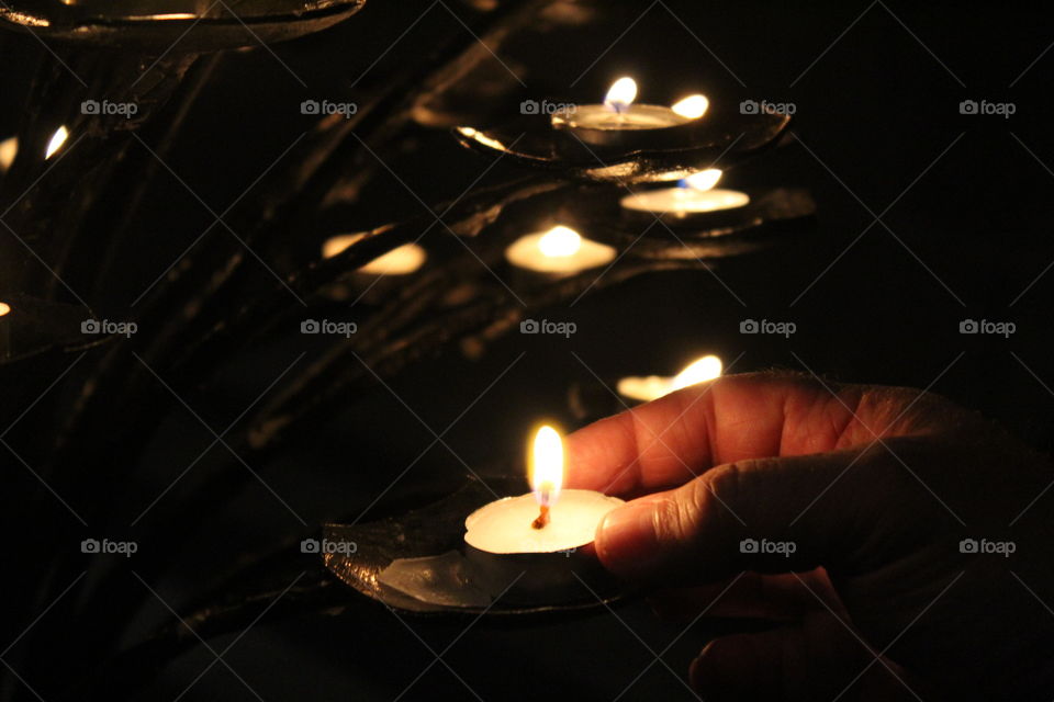Candles,  flame and hand