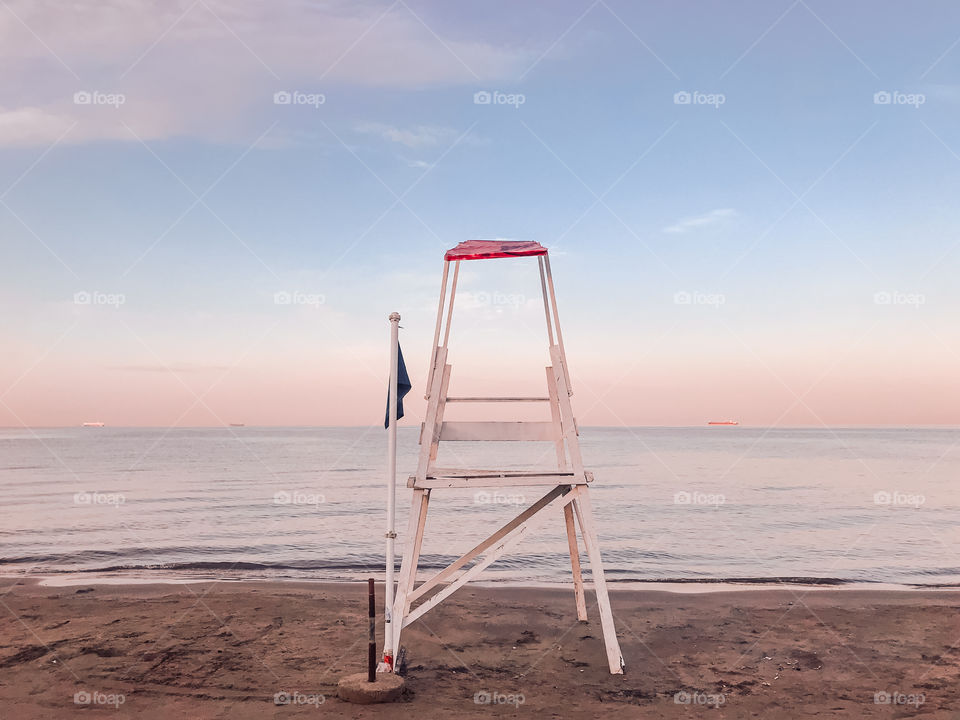 Lifeguard hut on beach against sky. 