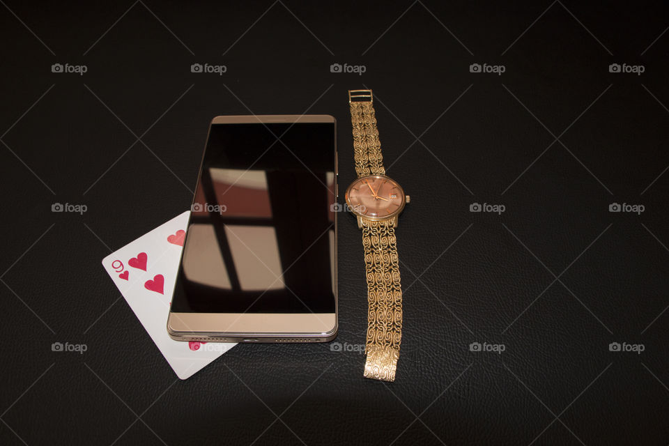 nine of a heart, watch and a mobile phone