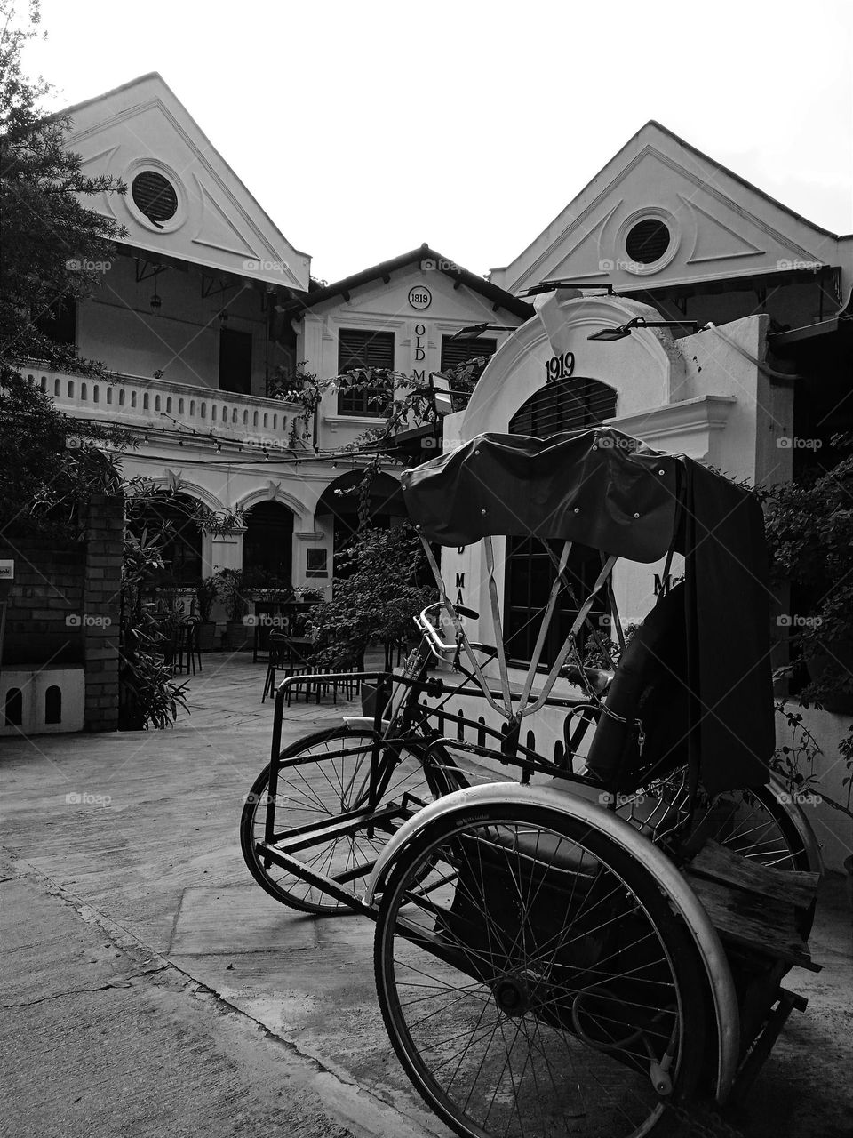 Tricycle in front of the old building.